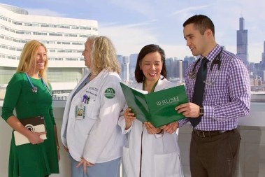 Four people talking on a rooftop