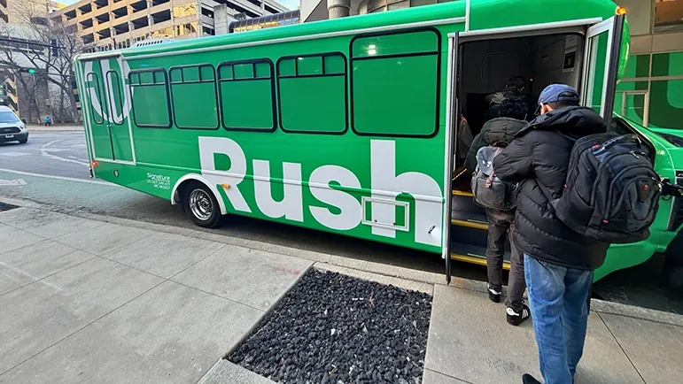 A shuttle bus with the Rush logo on the side