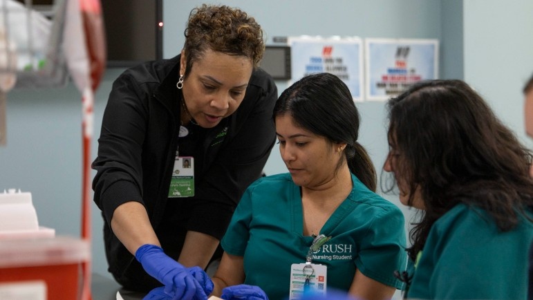Rush University nursing students practice IV insertion. 